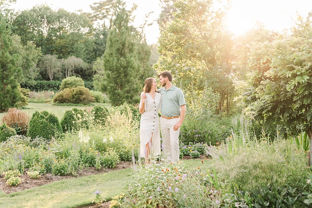 couple walking in gardens during their engagement session