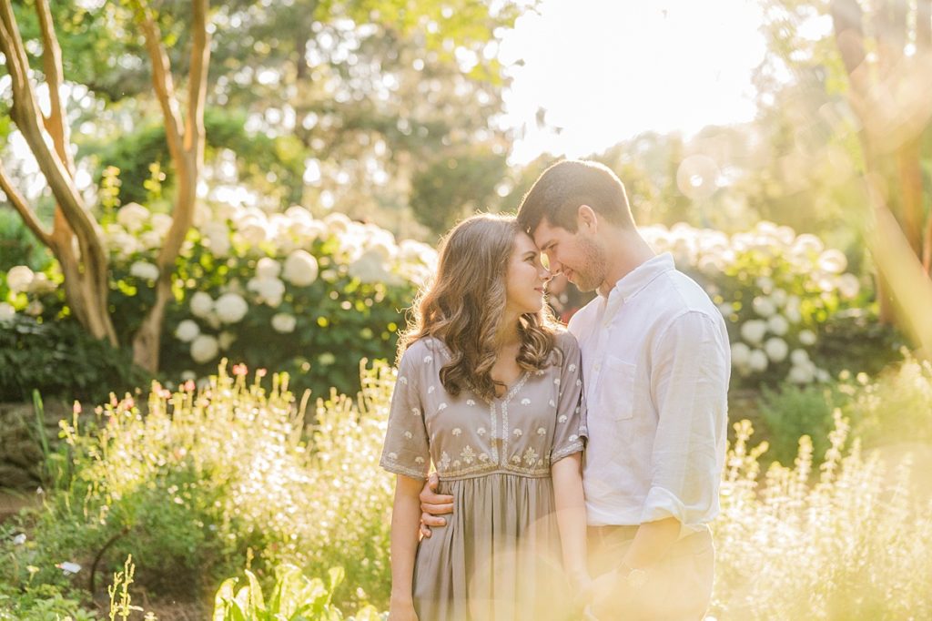 couple sharing a sweet moment during their engagement session in the tanglewood gardens