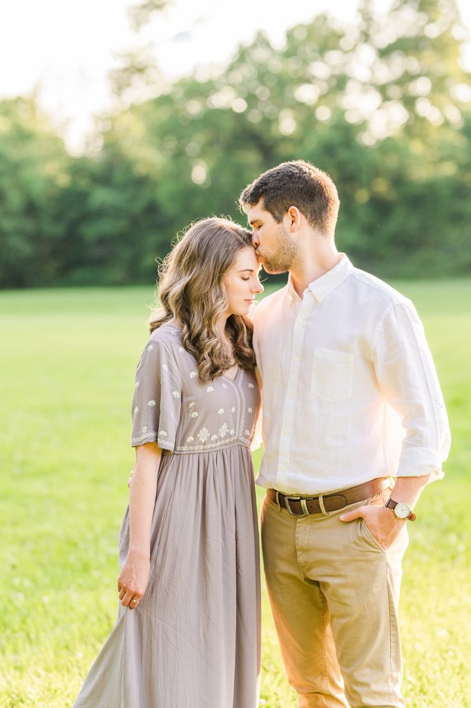 groom kissing brides forehead during Clemons nc engagement photos