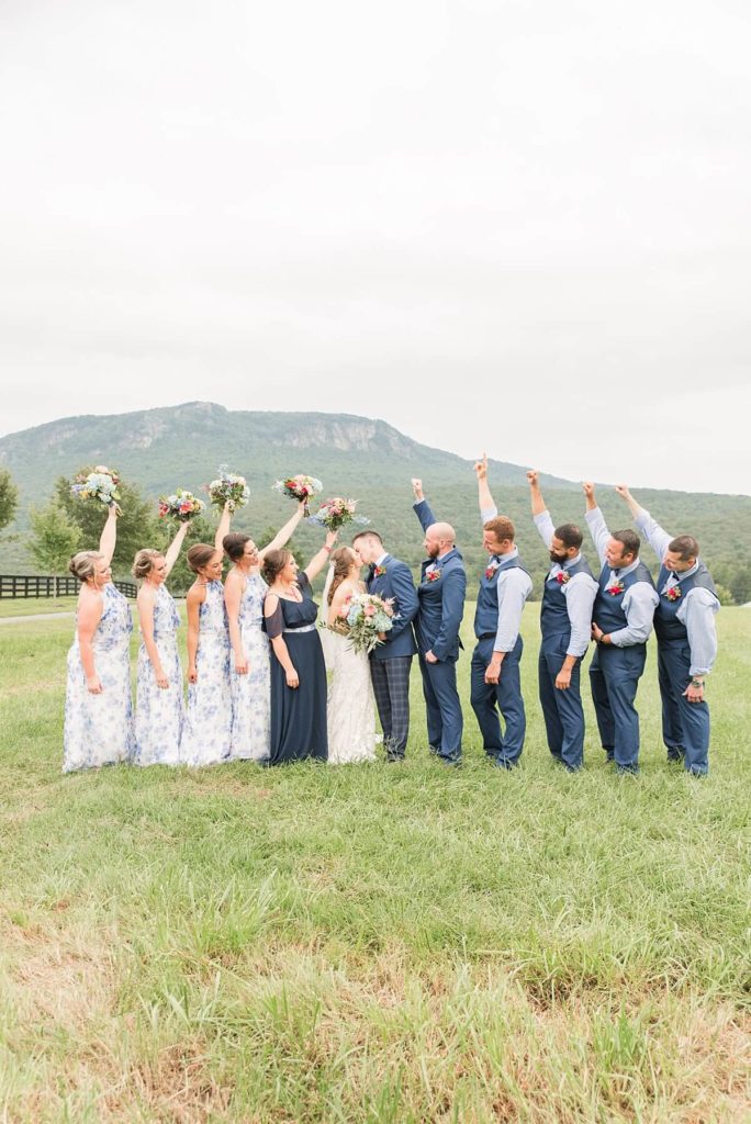 Bridal party celebrating bride and groom in front of the mountain views at Moores spring manor 