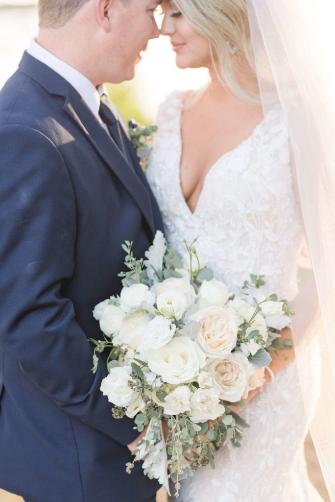 picture of bride and groom holding bridal bouquet at reynolda gardens 