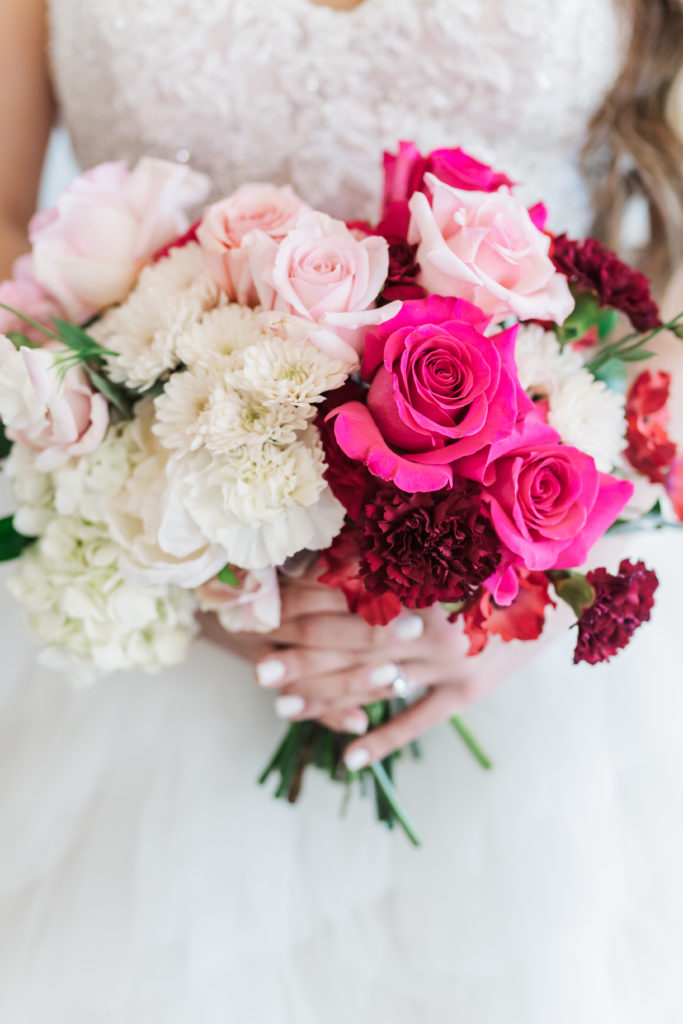 picture of a bridal bouquet with the bride holding it